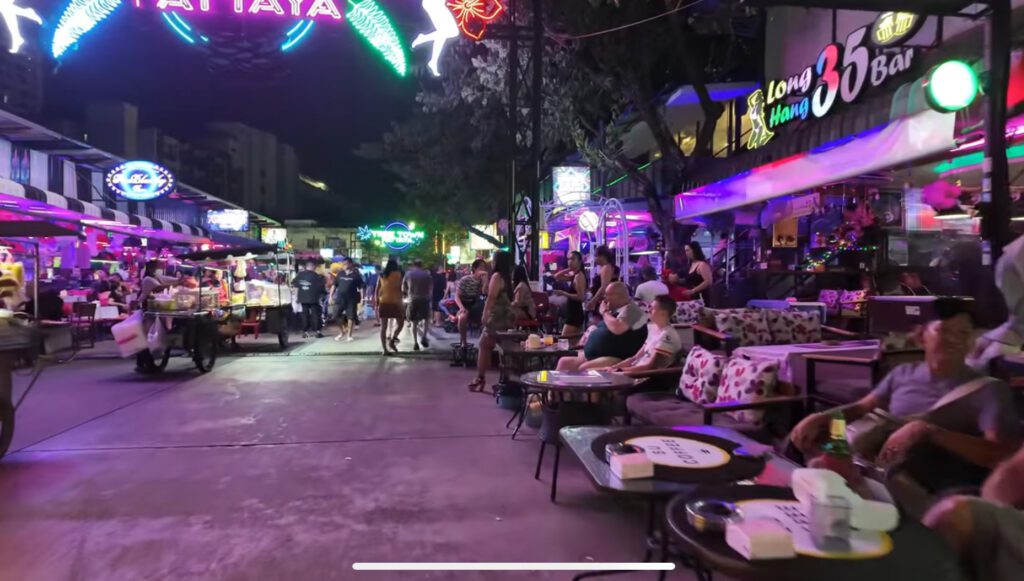 Close-up of Treetown Pattaya bar area with neon lights, bar stools, and expats socializing at night in 2025